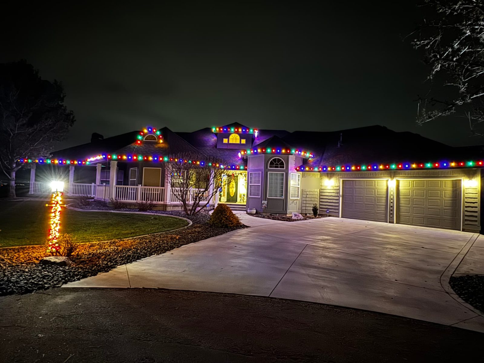 Boise home with professionally installed warm white Christmas lights at night