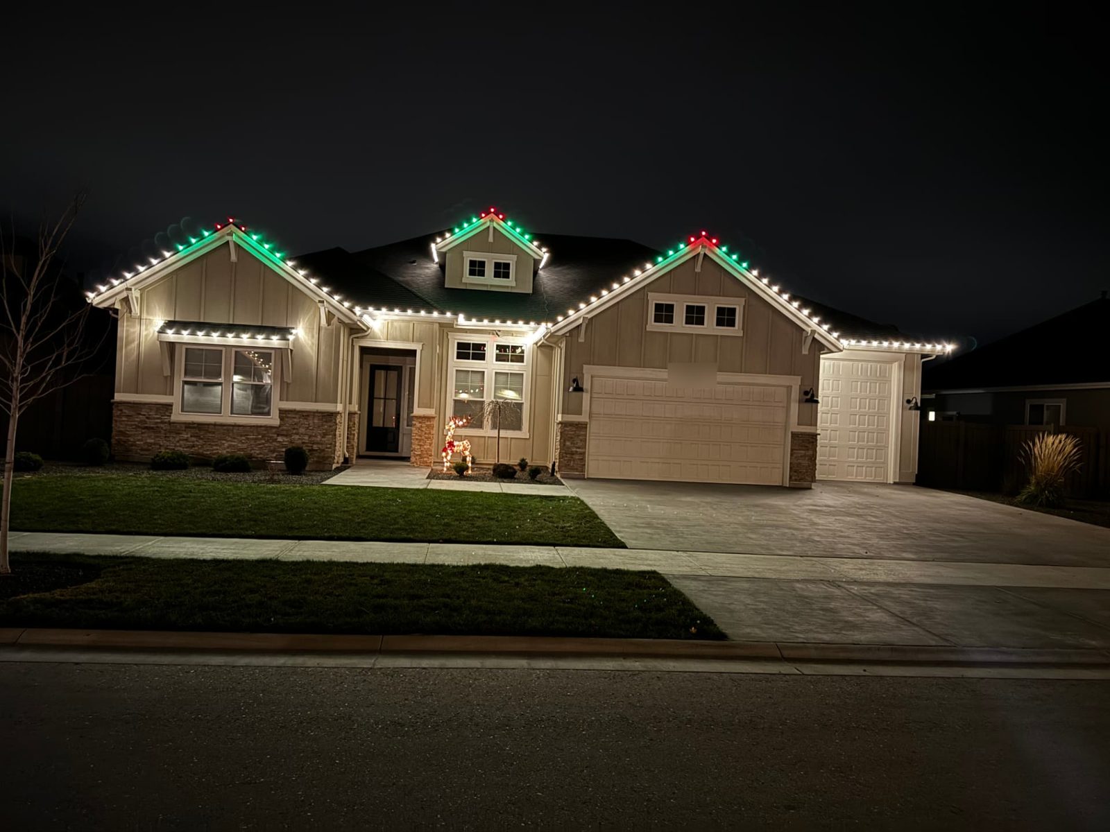 Warm white rooflines with green and red peaks on a Boise-area craftsman home
