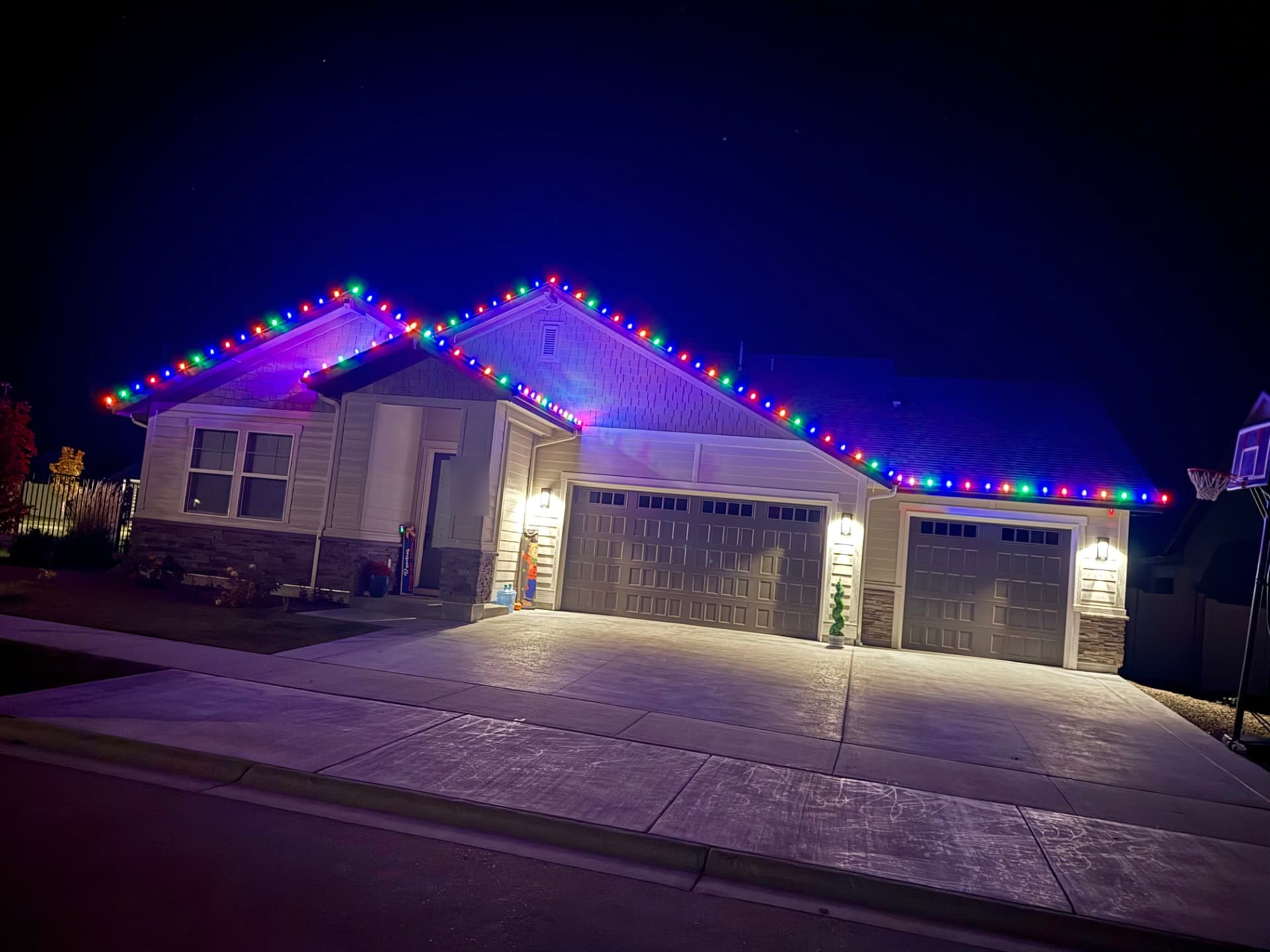 Multicolor RGBW smart C9 lights on the rooflines of a Treasure Valley home